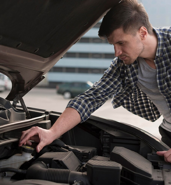Man inspecting car engine