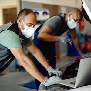 Mechanics inspecting a car