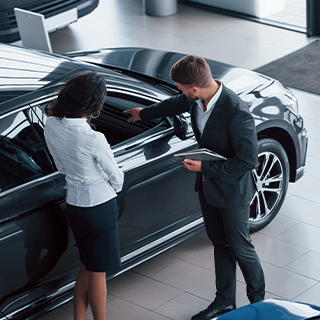 Professional discussing luxury car maintenance