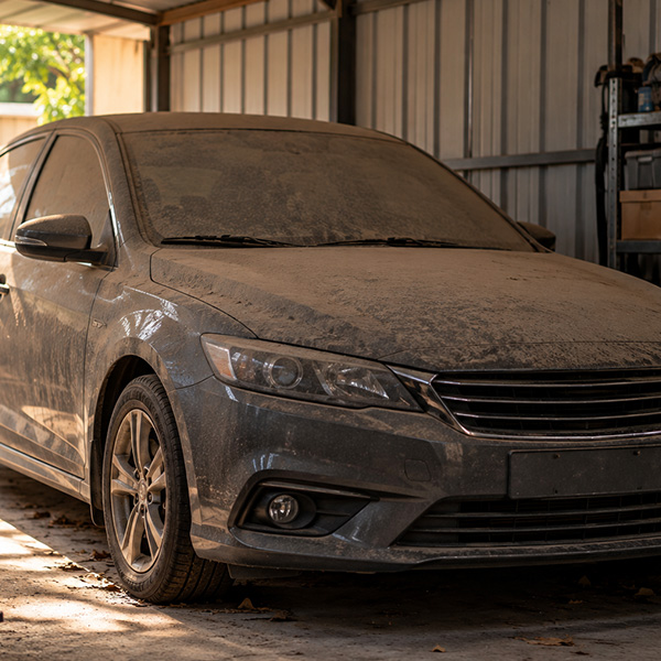 Dusty car in a garage.